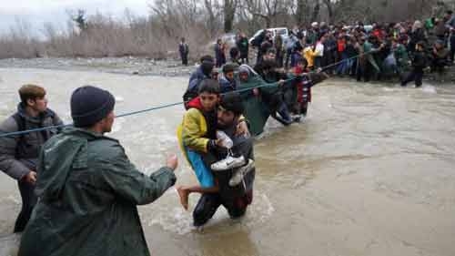 Hundreds of migrants march out of Greek camp, cross to Macedonia