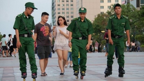 Security guards skate for faster patrol in downtown Ho Chi Minh City