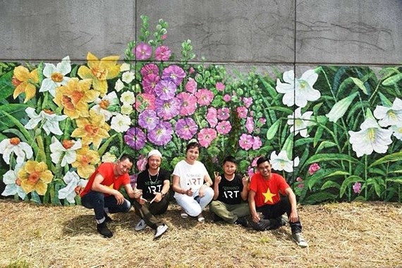 French, Vietnamese flowers featured on dyke wall along Seine river bank