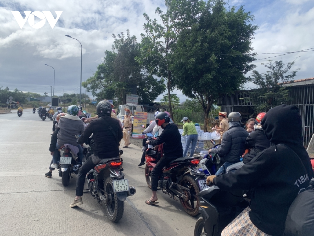 canh sat giao thong Dak nong phat nuoc uong, banh mi cho nguoi dan tro lai sau tet hinh anh 2